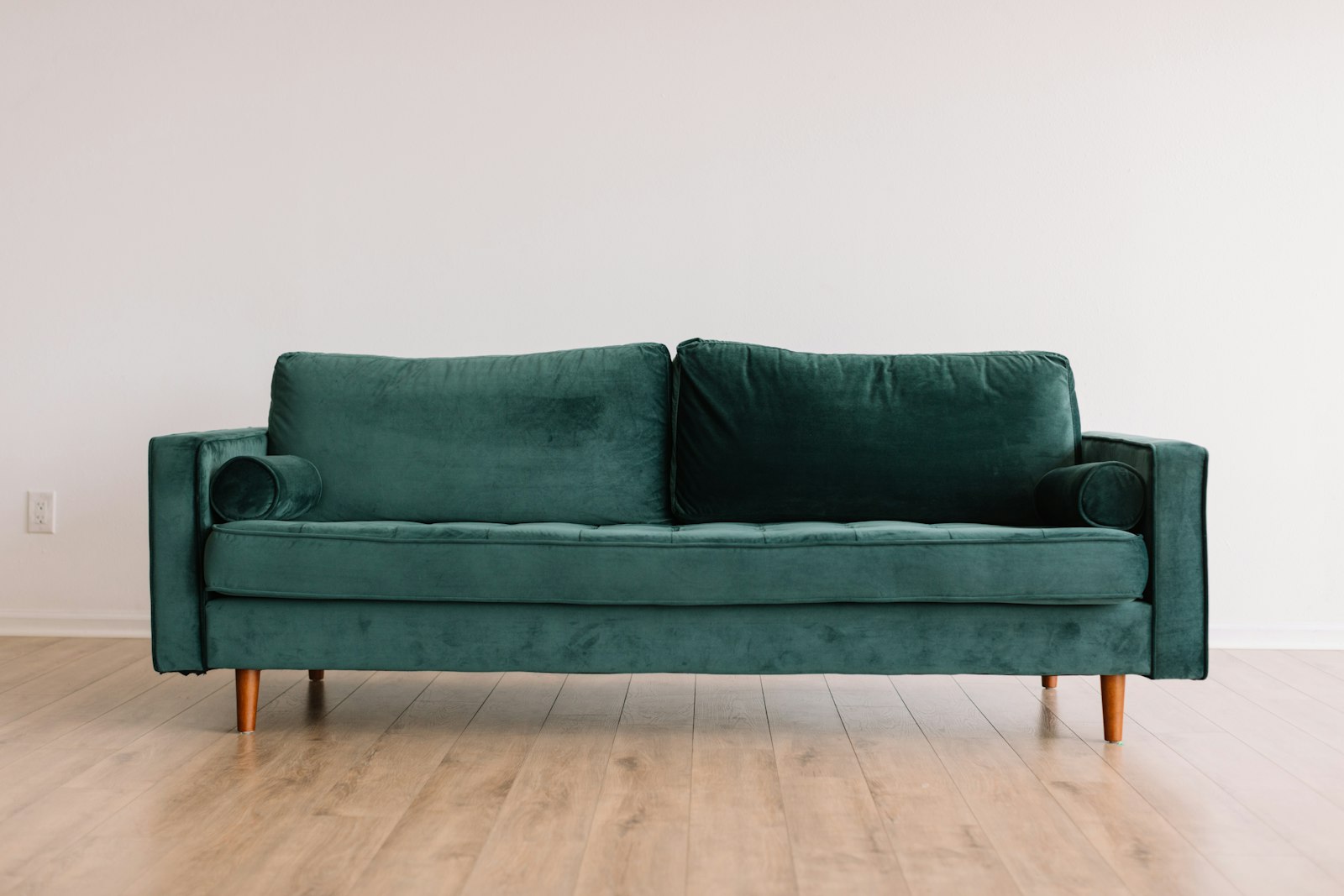 Deep green velvet two-seat sofa